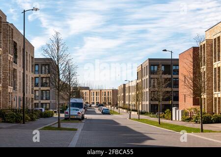 A view along Osprey Drive showing some of the new build apartment blocks in Trumpington Meadows, Cambridge, UK Stock Photo