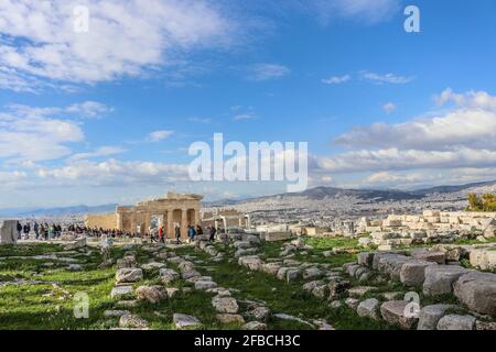 01-03 2018 Athens Greece - View from Accropolis  showing city stretching up mountains and all the way to the sea with tourists among broken pillars an Stock Photo