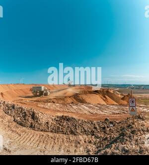 Clear blue sky over open-pit mine Stock Photo