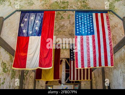 07-31-2010 Fr Augustine Texas - Historical flags that have flown over  at St Augustine Florida - one of the oldest forts in the USA inside concrete gr Stock Photo