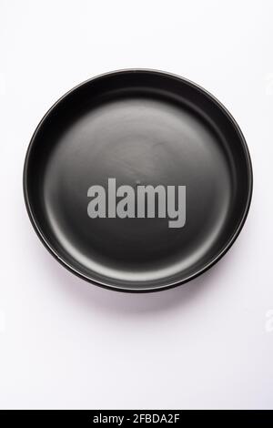 Empty black ceramic serving bowl, isolated over white or gray background Stock Photo