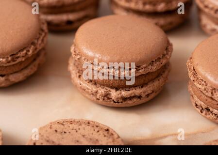 brown macarons with chocolate cream, on a wooden table Stock Photo