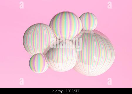 Yellow, green and pink pastel bubbles against pink background Stock Photo
