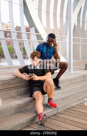 Young man looking at male friend Stock Photo