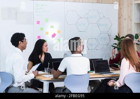 Male and female entrepreneurs having discussion in board room at office Stock Photo