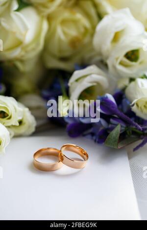 Wedding theme, beautiful wedding rings, bridal bouquet Stock Photo