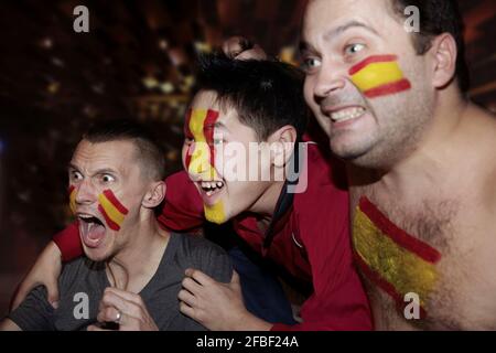 Soccer fans watching TV in pub Stock Photo