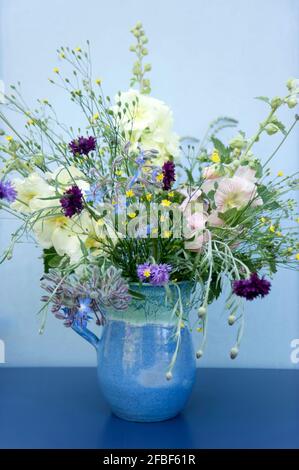 Summer flowers in blue jug Stock Photo