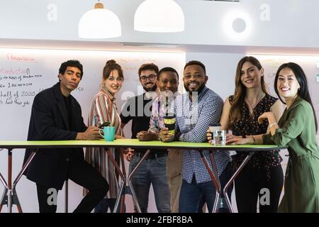 Smiling male and female professional at table in office Stock Photo