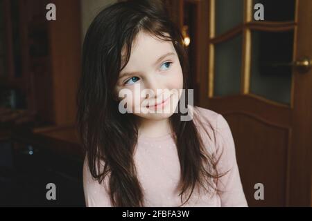 Curious girl with blue eyes looking away at home Stock Photo