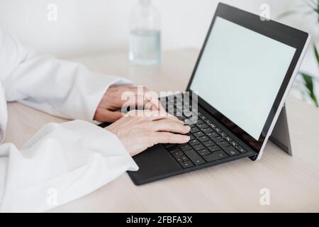 Female medical professional using digital tablet at desk in medical clinic Stock Photo