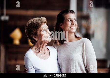 Smiling senior woman with granddaughter looking away Stock Photo