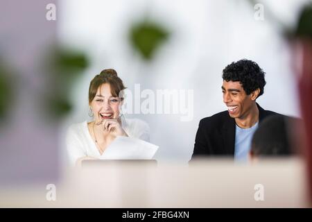 Cheerful male and female colleagues at office Stock Photo