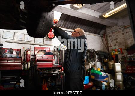 Male car mechanic working in garage Stock Photo