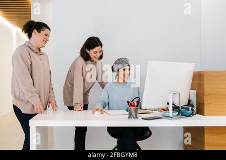Female orthodontists using computer at desk in office Stock Photo