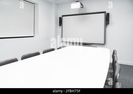 Empty illuminated board room in coworking office Stock Photo