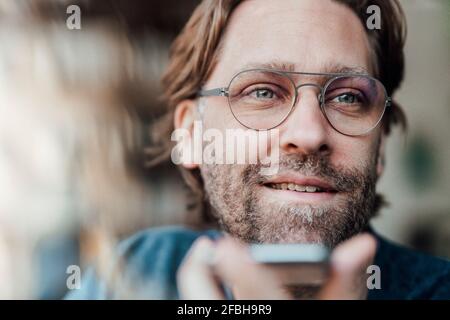 Smiling man looking away at cafe Stock Photo