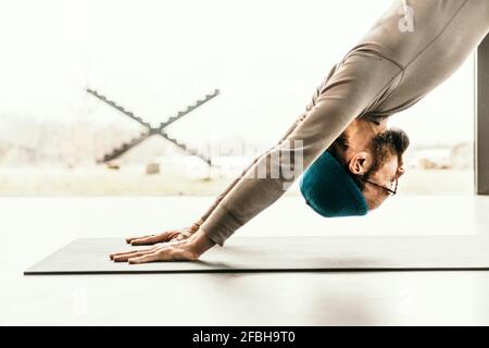 Male yoga teacher practicing yoga Stock Photo