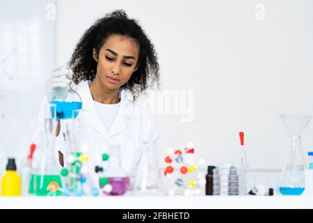 Young female chemist working in a chemistry lab Stock Photo