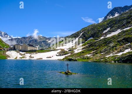 Italy, Aosta Valley, Great Saint Bernard Lake in front of Great Saint Bernard Hospice at Great Saint Bernard Pass Stock Photo
