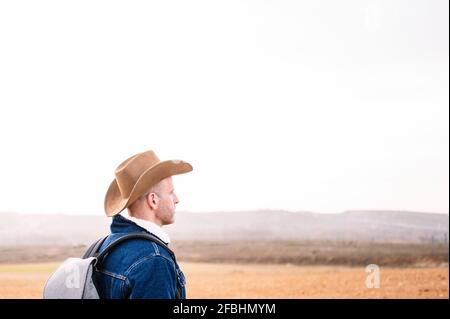 Man in hat looking at view Stock Photo