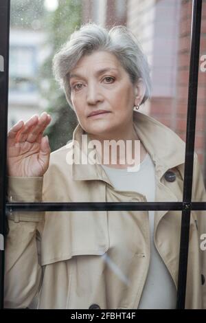 Portrait of mature woman looking through binoculars, Sedona, Arizona