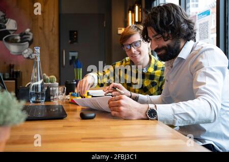 Smiling male entrepreneur planning strategy while working in office Stock Photo