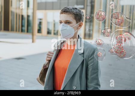 Woman wearing face mask in the city to protect herself from corona viruses Stock Photo
