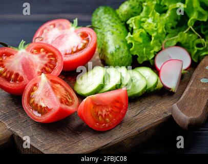 various fresh sliced vegetables on cutting board Stock Photo