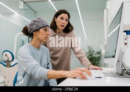 Female doctor talking while working with colleague in clinic Stock Photo
