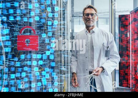 Male technician holding cable at data center Stock Photo