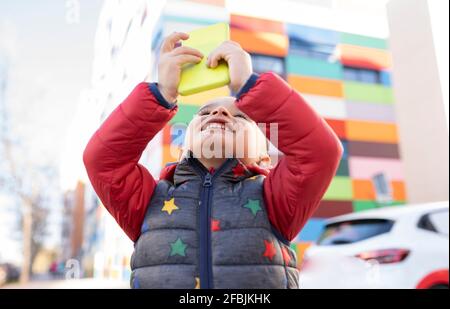 Smiling boy using mobile phone Stock Photo