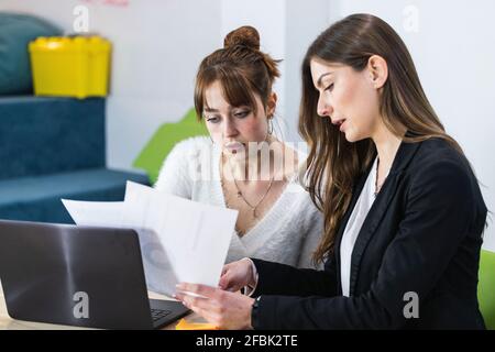 Young entrepreneurs working over document in office Stock Photo