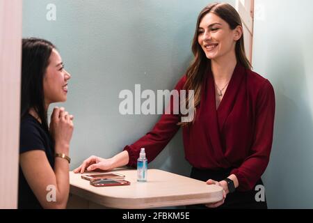 Businesswomen talking at cafeteria in office Stock Photo