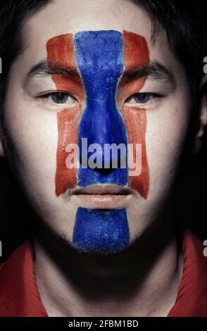 Young man with Korean flag painted on face Stock Photo