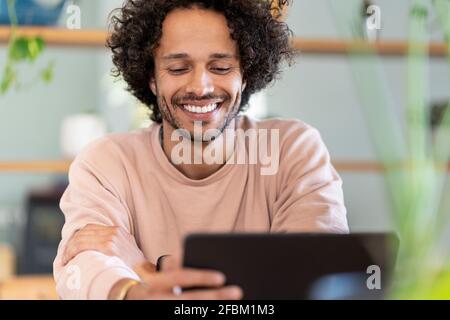 Cheerful male entrepreneur using digital tablet at home Stock Photo