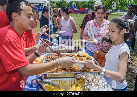 Miami Florida,Tropical Park Drug Free Youth In Town DFYIT,teen student anti addiction group picnic,buffet table food Hispanic boy girl serving, Stock Photo