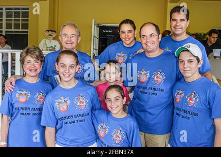 Florida Key Biscayne St. Agnes Church Betancourt Family Reunion,Cuban Hispanic extended family wearing matching tee shirts crest,children parents rela Stock Photo