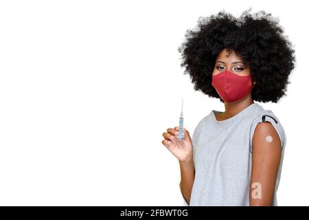 young teenager wearing a covid-19 protective mask being vaccinated COVID-19 Stock Photo