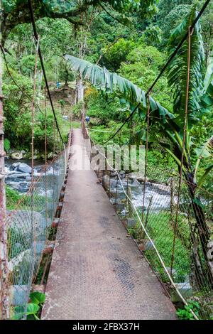 Suspension bridge over Caldera river near Boquete Panama , on Lost Waterfalls hiking trail. Stock Photo