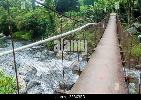 Suspension bridge over Caldera river near Boquete Panama , on Lost Waterfalls hiking trail. Stock Photo