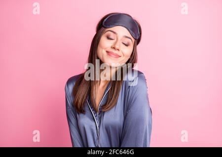 Photo portrait of delighted smiling woman with closed eyes isolated on pastel pink colored background Stock Photo