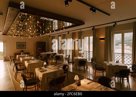 The interior of the restaurant is square tables, chairs and large windows. Stock Photo