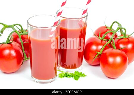 Fresh homemade tomato juice in the glasses on white background. Stock Photo