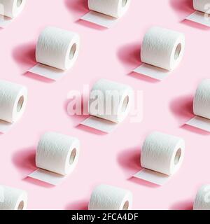 White toilet paper roll repeat seamless pattern on light pink background. Stock Photo