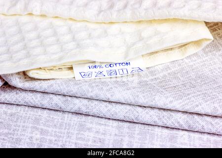 Pure natural light shades cotton fiber fabric with cloth label. Stock Photo