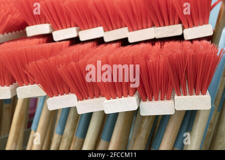Hardfloor Care professionals Cleaning Equipment in Store. outdoor Floor Cleaning Heads of Broom, Heavy Duty Floor Sweepe broom with bright red plastic Stock Photo