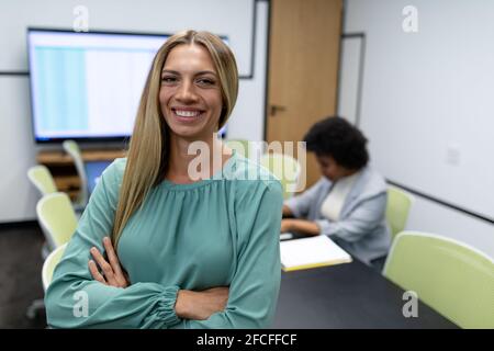 Portrait of caucasian businesswoman in meeting room looking to camera and smiling Stock Photo