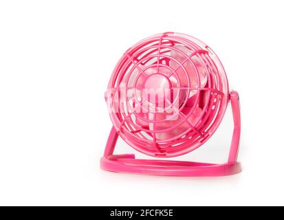 Mini fan. Portable battery operated hot pink small table ventilator to cool down and circulate air during hot summer days. Use at the office, car trip Stock Photo