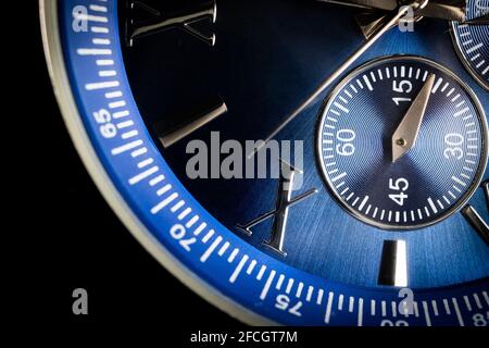 Macro Close Up of Roman Numeral Ten on Blue Faced Chronograph Watch Stock Photo